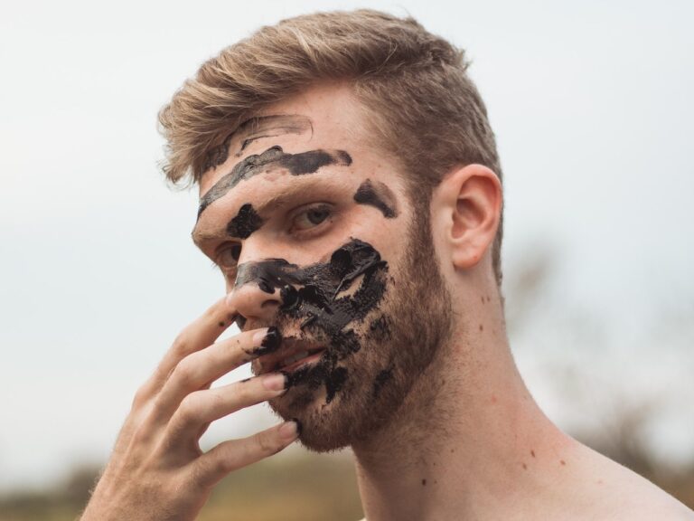 Man holding his muddy face