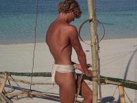 Christopher Atkins in loincloth building boat