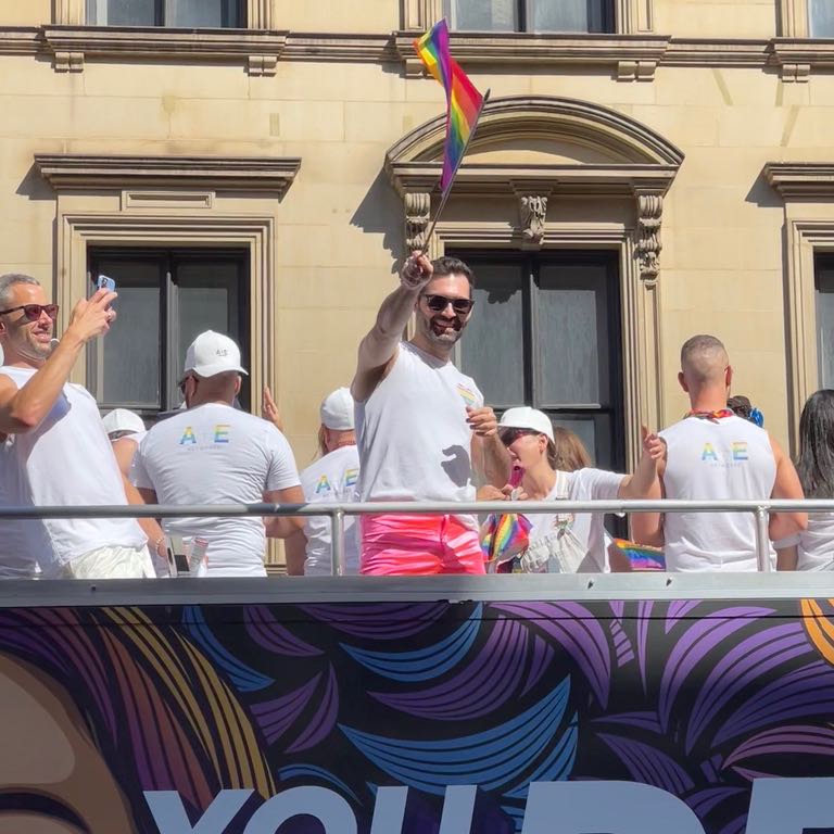 Man with rainbow flag on A&E Networks float