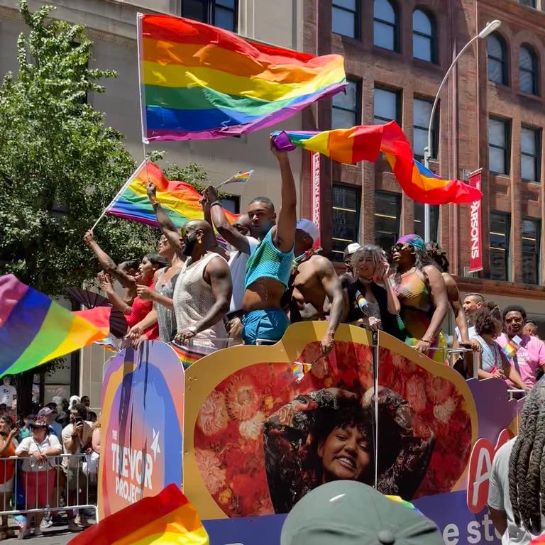 Men on Trevor Project float waving rainbow flags